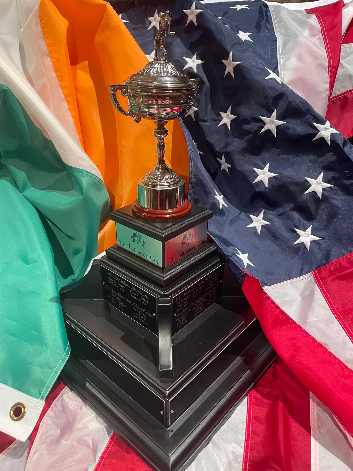 The Killarney Cup displayed between the flags of Ireland and the United States
